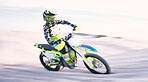 Bike, sand and speed with a sports man riding a vehicle in the desert for adventure or adrenaline. Motorcycle, training and freedom with an athlete outdoor in nature for power or active competition