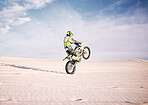 Bike, space and balance  with a sports man riding a vehicle in the desert for adventure or adrenaline. Motorcycle, training or freedom and an athlete on sand in nature for skill or power with mockup