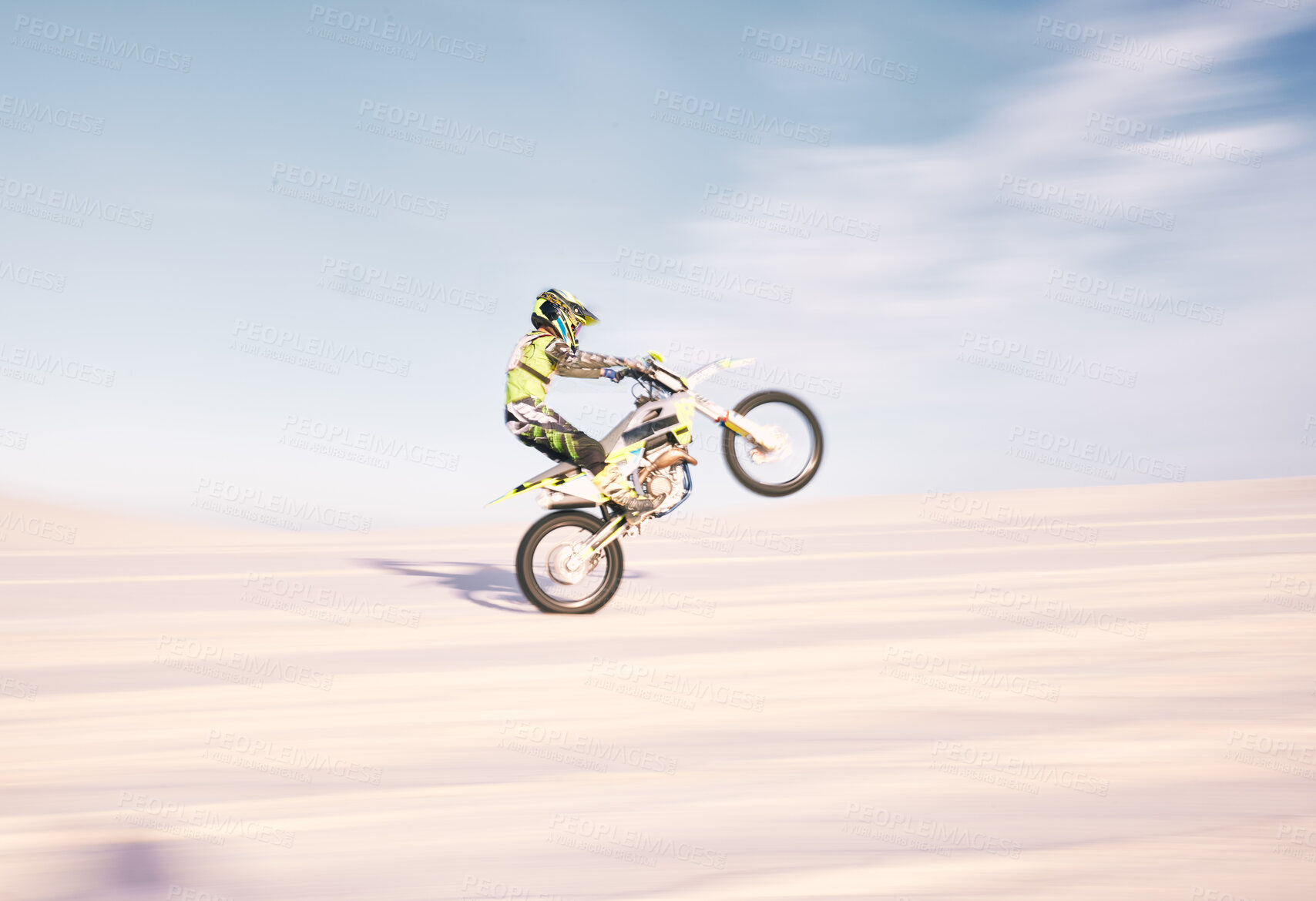 Buy stock photo Bike, speed and balance with a sports man riding a vehicle in the desert for adventure or adrenaline. Motorcycle, training and motion blur with an athlete outdoor in nature for freedom or power