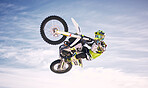 Sky, jump and man on off road motorbike for practice, training and extreme sports energy in nature. Professional dirt biking adventure challenge, person in clouds and danger in motorcycle competition