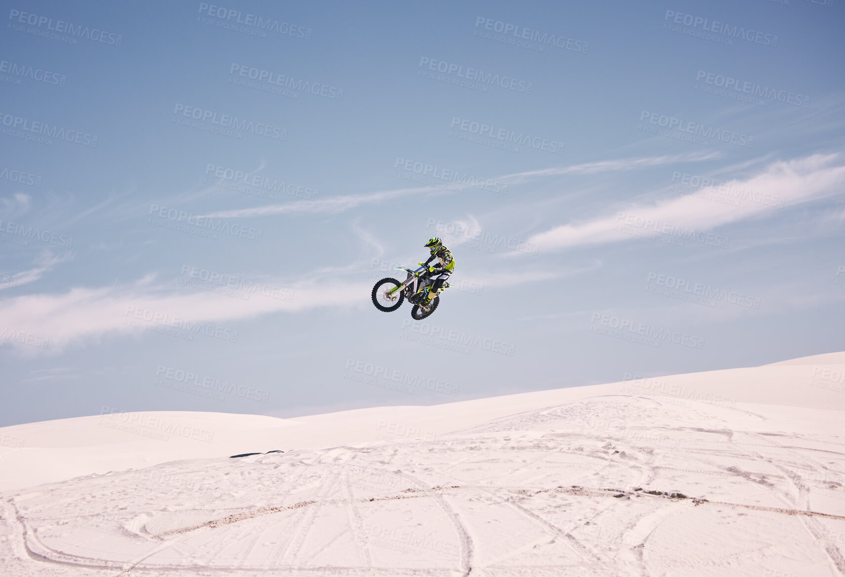 Buy stock photo Bike, sky and jump with a man in the desert riding a vehicle for adventure or adrenaline. Motorcycle, speed and training on sand with an athlete outdoor in nature for freedom or extreme sports