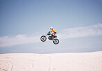 Motorcycle, mockup and sky with a man in the desert riding a vehicle for adventure or adrenaline. Bike, jump and training with an athlete in the air in nature for freedom, power or active competition