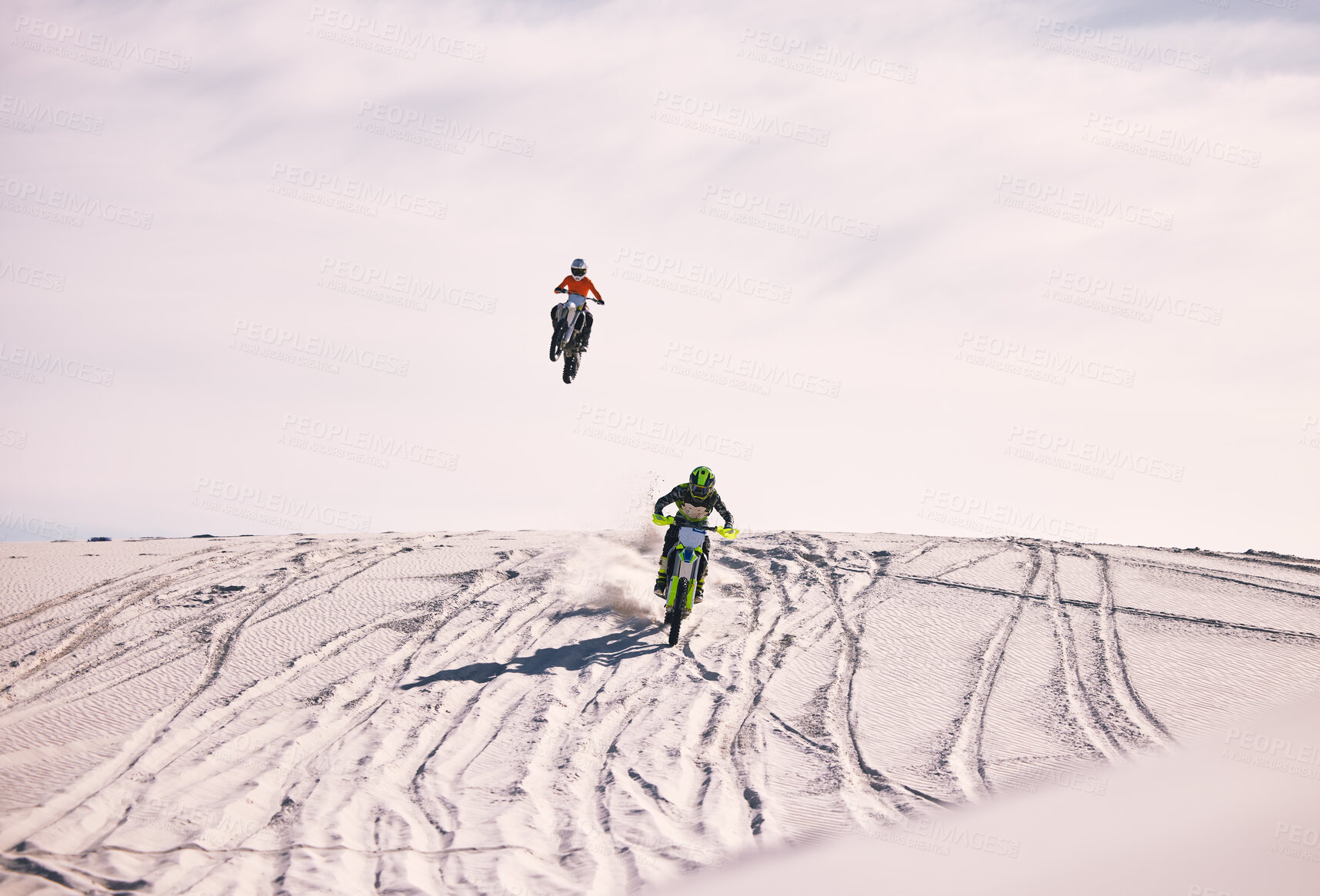 Buy stock photo Dune, jump and men in motorbike race together for practice, training and extreme sports energy. Professional dirt biking challenge, friends and danger with off road motorcycle competition in desert.