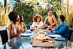 People, food and friends outdoor at a table for social gathering, happiness and holiday celebration. Diversity, men and women group eating lunch at party or reunion with drinks to relax in a garden