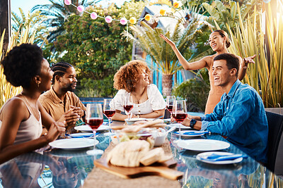 Buy stock photo Friends, food and eating outdoor at a table for social gathering, happiness and holiday celebration. Diversity, men and women group at lunch, party or reunion with drinks in garden for fun and relax