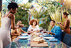 Food, friends and happy people outdoor at a table for social gathering, happiness and holiday celebration. Diversity, men and women group eating lunch at party or reunion with wine to relax in garden