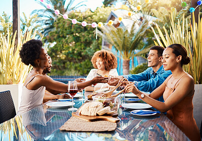 Buy stock photo Friends, food and outdoor at a table for celebration, social gathering, happiness on holiday. Diversity, men and women group eating lunch at a party or reunion with drinks in garden for fun and relax