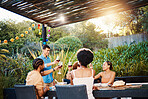 Cheers, friends at dinner in garden at party and celebration with diversity, food and wine at outdoor party. Glass toast, men and women at table, fun people with sunset drinks in backyard together.