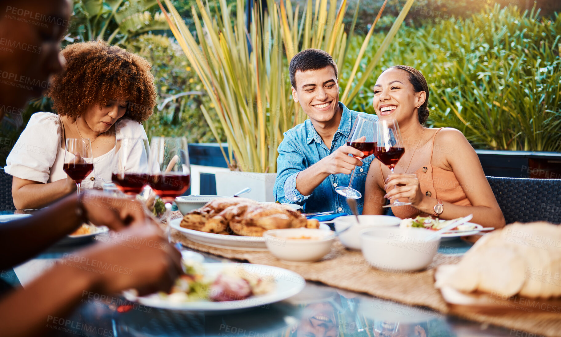 Buy stock photo Happy, friends and cheers with wine glass at restaurant, bonding and having fun. Smile, alcohol and group of people toast at dinner party, celebration and drink, eating food and together at table