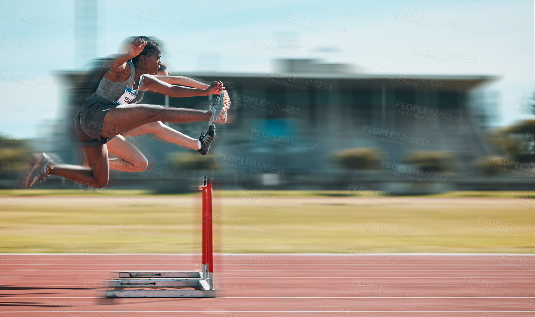 Buy stock photo Fast, hurdles and team of women on track running in race, marathon or competition in stadium. Fitness, workout and female athletes jumping with speed and energy for outdoor training with blur motion.