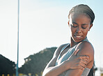 Fitness, running and a black woman with pain in arm from outdoor exercise, training and field sports. Accident, young and an African athlete with a muscle injury from a workout, cardio or emergency