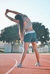 Exercise, stretching and sports woman outdoor at a stadium for workout, training and warm up. Back of athlete person for muscle stretch, fitness and wellness or flexibility for a run or competition