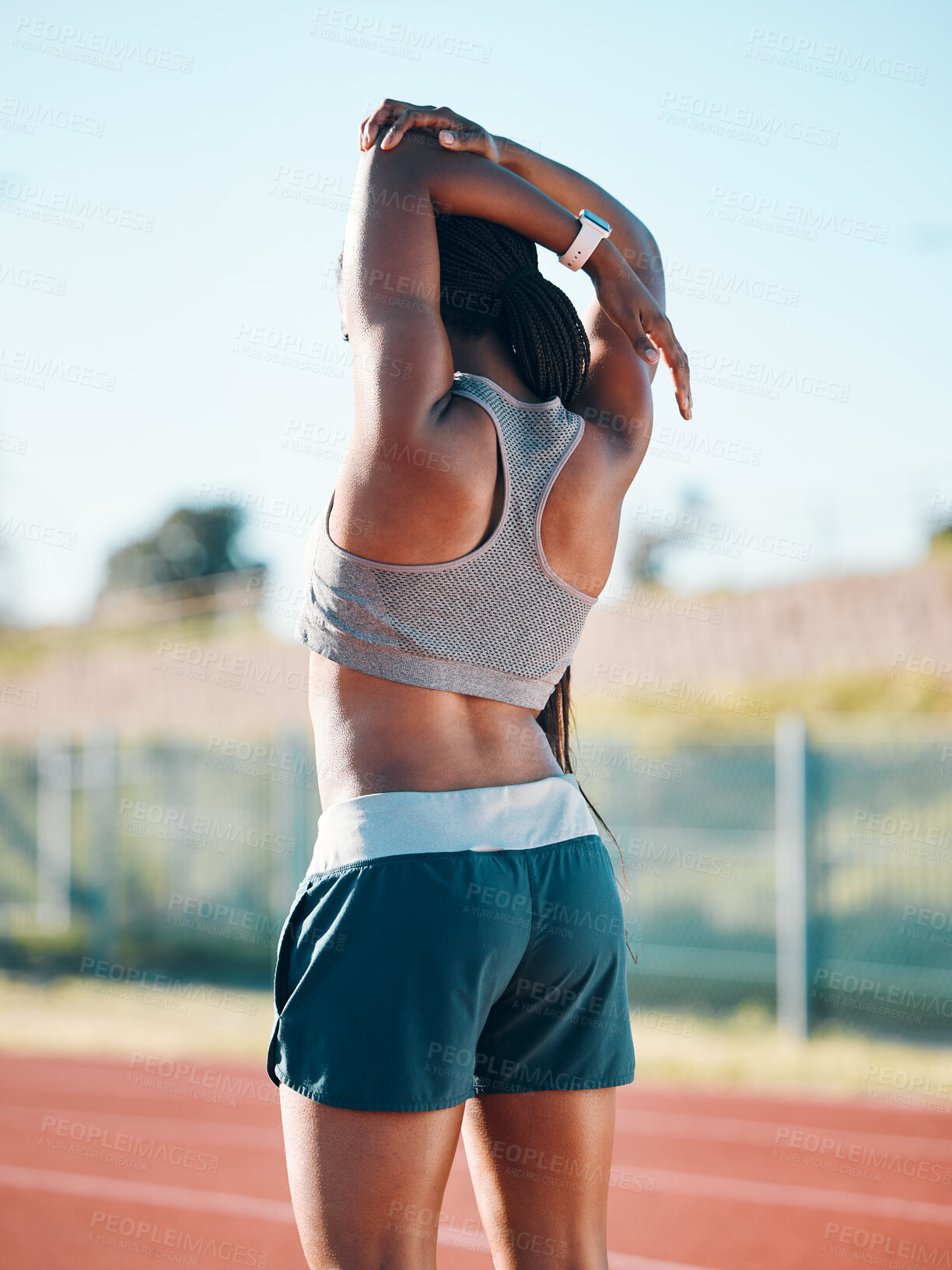 Buy stock photo Stretching, sports and exercise with a woman outdoor on a track for running, training or workout. Behind African athlete person at stadium for arm stretch, fitness and muscle warm up or body wellness