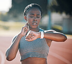 Time, pulse and exercise with a woman outdoor on a track for running, training or workout. African athlete person at stadium for goals, fitness and body wellness with a watch for progress or steps