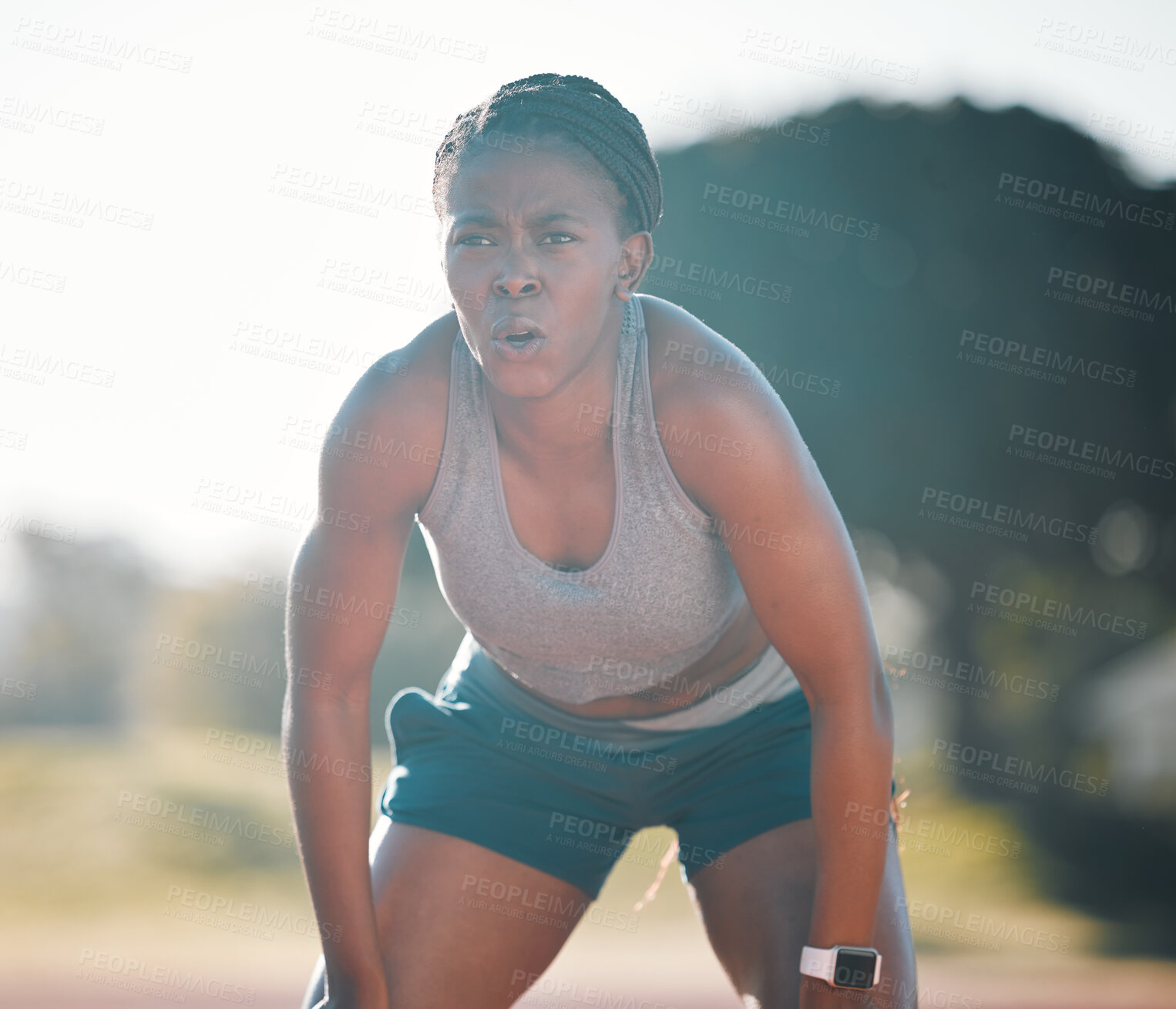 Buy stock photo Break, tired and a black woman at a stadium for a workout, training or breathing after cardio. Sports, race and an athlete or African runner with an idea for fitness, running or exercise on a track