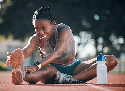 Buy stock photo Sports, stretching and exercise with a woman outdoor on a track for running, training or workout. Happy African athlete person at stadium for legs stretch, fitness and muscle warm up or body wellness