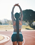 Sports, stretching and exercise with a woman outdoor on a track for running, training or workout. Behind African athlete person at stadium for arm stretch, fitness and muscle warm up or body wellness