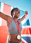 Exercise, winning and black woman with celebration, UK flag and sports with competition, achievement and champion. African person, athlete or winner with British symbol, pride and medal for victory