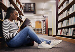 Research, book and a black woman in a library for reading, college knowledge or studying on the floor. Scholarship, student and an African girl at a university or a bookshop for education or learning