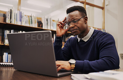 Buy stock photo Man, student and thinking on laptop in library for studying, university research or headache and stress of debt or results. Young and confused african person on computer for education FAQ or question