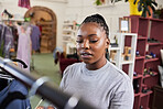 Shopping, woman and clothes rail for fashion at a retail store with sale or discount. A black person or customer in a shop for product choice, promotion or designer brand in a boutique or mall 