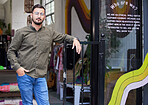 Man, portrait or fashion shop door of clothes, thrift store or workshop entrance to sale, cool or charity clothing. Confident professional, designer or small business owner in retail donation startup