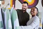 Retail, store and interracial couple shopping for fashion or style together in a mall and happy for clothes. Customer, man and woman on a date for bonding on vacation or holiday and purchase outfit