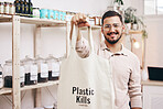 Man at eco friendly grocery store, recycling shopping bag and commitment to climate change at sustainable small business. Zero waste, plastic kills logo and supermarket with carbon footprint choice.