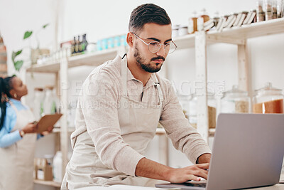 Man, small business and store for typing, laptop and notes with stock, supply chain and thinking with sustainable ideas. Entrepreneur, partnership and inventory checklist for product, woman and shop