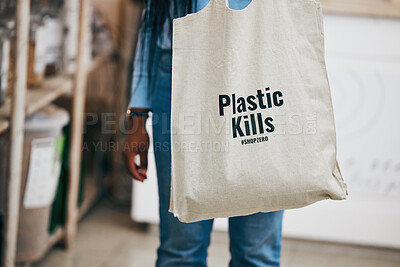 Buy stock photo Person in eco friendly grocery store, recycling shopping bag and commitment to climate change at sustainable small business. Zero waste, plastic kills logo and supermarket carbon footprint choice.