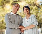 Portrait, outdoor and senior couple holding hands, love and smile with support, relationship and romance. Marriage, old man and mature woman in a park, loving together and retirement with bonding