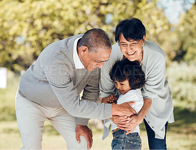 Buy stock photo Happy, hug and grandparents with child in park for playing, love and support. Care, smile and freedom with family and embrace on nature path for peace, summer vacation and happiness together