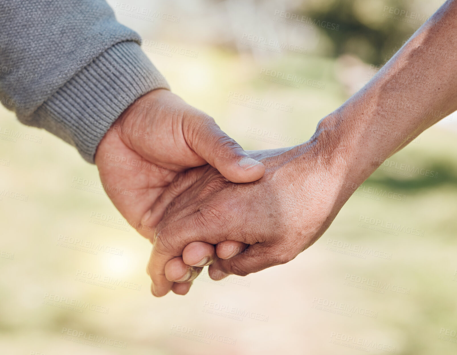 Buy stock photo Holding hands, closeup and support, trust and love with people outdoor, solidarity and care while in nature. Healthy relationship, bond and wellness, commitment and comfort with peace and partner