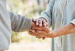 Senior couple, holding hands and love with support in outdoor, nature or bonding in backyard with care, comfort or kindness. Helping, hand and people in retirement together with empathy and trust