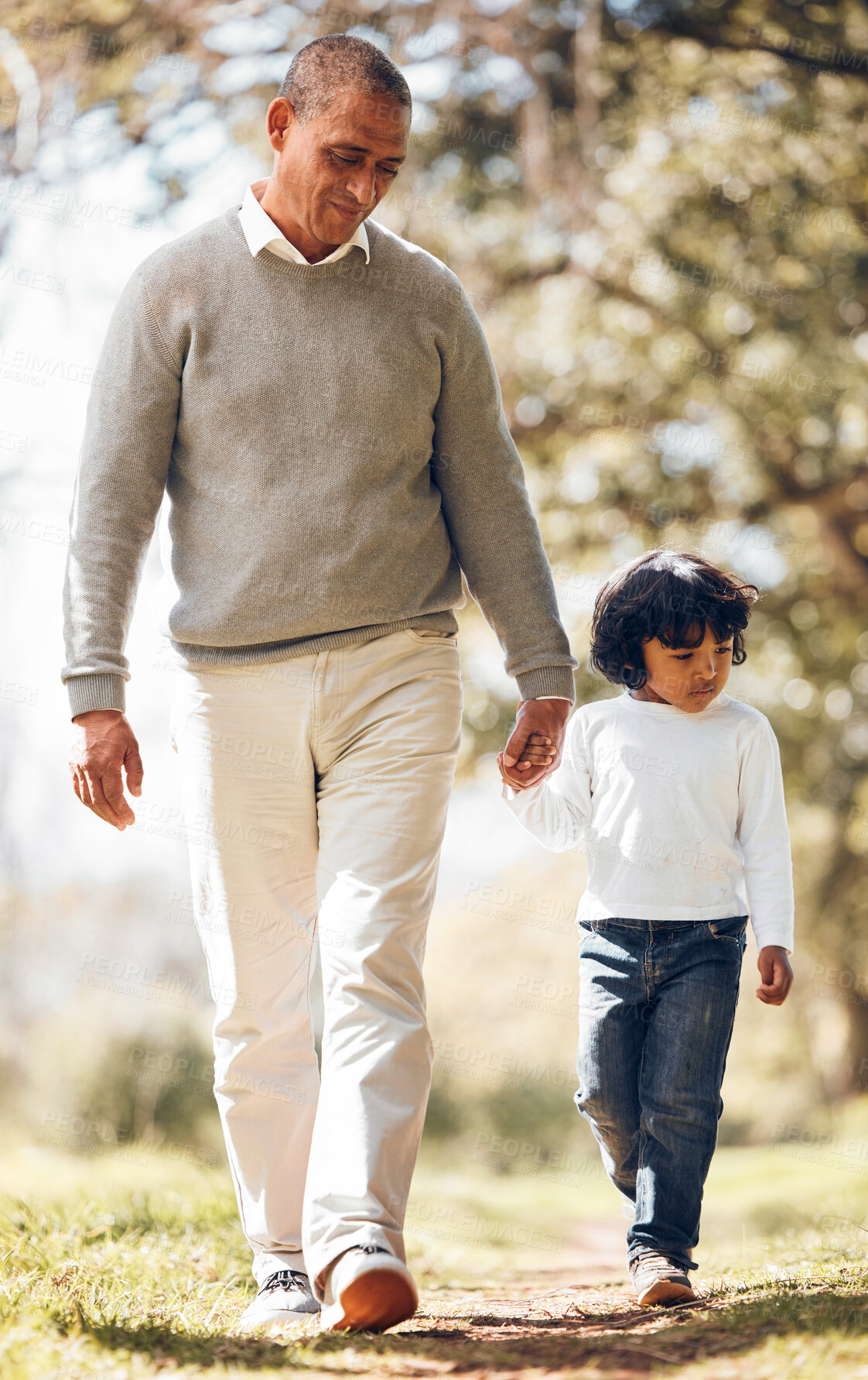 Buy stock photo Grandpa, grandchild and holding hands in the park while walking together in nature for family bonding. Summer, freedom or adventure with a senior man and cute granddaughter outdoor in a garden