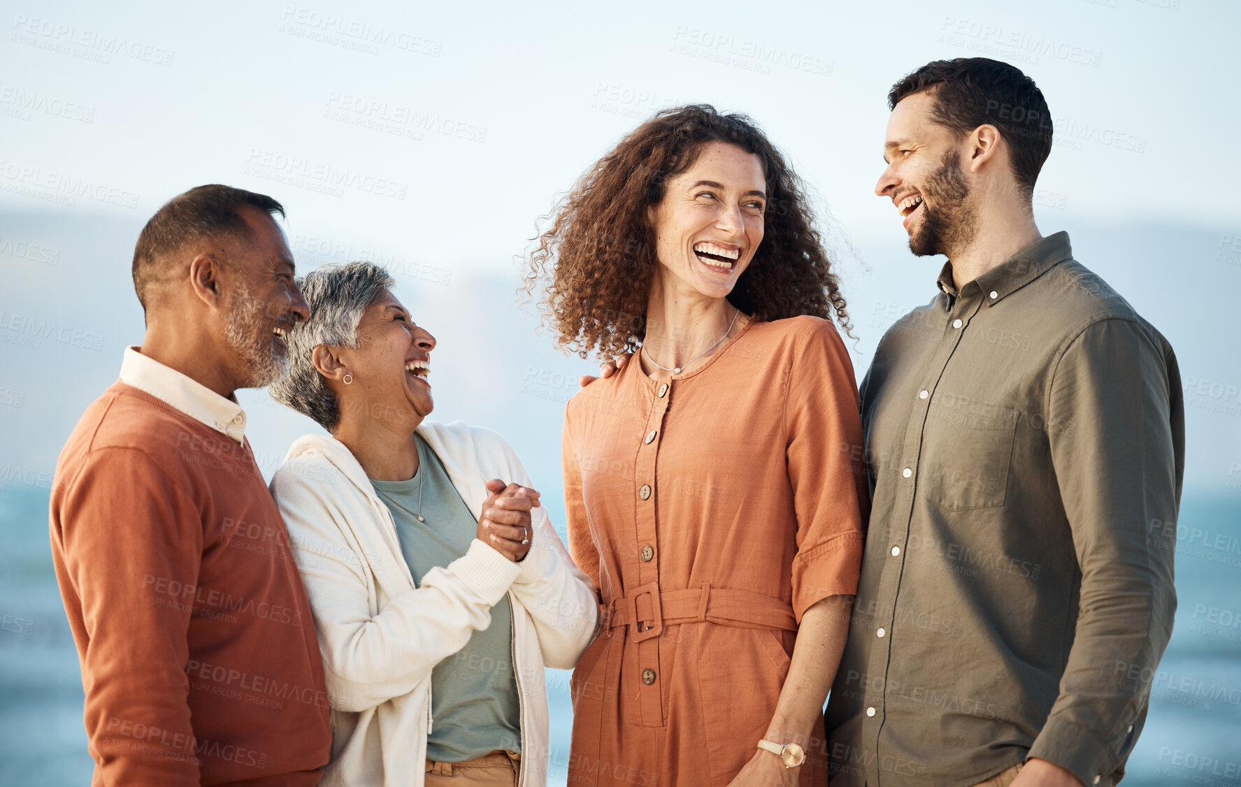 Buy stock photo Funny, summer and travel with big family at beach for vacation, care and support. Love, smile and happiness with senior parents and couple laughing in nature for holiday, relax and bonding together