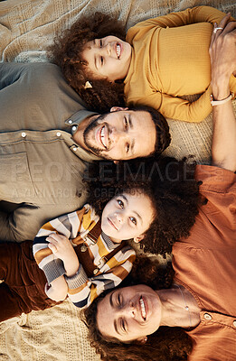 Buy stock photo Face, family and top view of children and parents lying down together, love and happiness with bonding. Trust, support and smile in portrait, mother and father relax with young girl children 