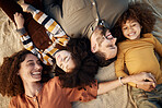 Picnic blanket, family laughing and bonding outdoor from above in a park with a smile, love and care. Mother, dad and children together with happy young and kids on holiday with mom and father