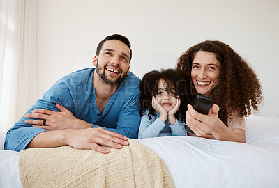 Buy stock photo Bedroom, happy family child and parents watching tv series, movie or streaming online video, cinema or theatre together. Bed, home and relax mom, dad and kid watch cartoon show, television or film