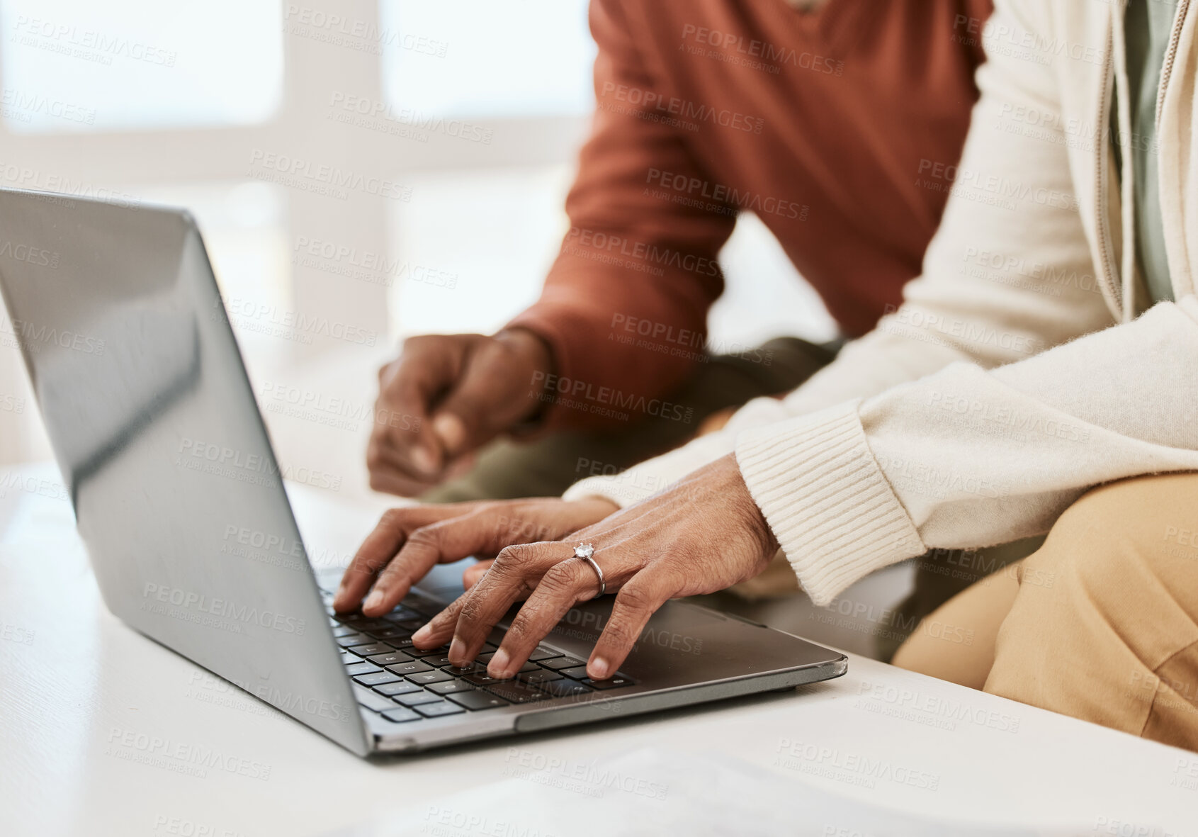 Buy stock photo Hands, closeup and a couple with a laptop for internet, connection or research. Table, home and people typing on a computer for mortgage information, email or together for a movie online on a pc