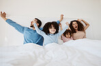 Family, bed and yawn in morning wake up, relax or sleep together with arms up at home. Calm parents, children and bonding on holiday break, weekend or new day in peace, support or comfort in bedroom