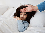 Sick, child and hand on head check for temperature, fever and disease in a bed with headache. Bedroom, tired and fatigue of a young kid with healthcare and flu problem with parent support and monitor