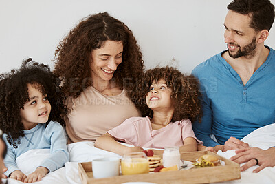 Buy stock photo Parents, children and happy family breakfast in bed, eating food and rest together, bond and relax in apartment. Home bedroom, morning meal and interracial kids, mom and dad wellness, love and care