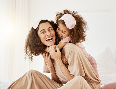 Buy stock photo Mother, daughter and sleep mask, hug and bonding with love, care and laughter in the morning. Woman, young girl and smile at home with pajamas and family, positivity and fun together in bedroom