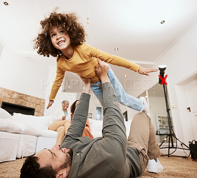 Buy stock photo Dad, kid and airplane game on floor in home living room, bonding and love with care, relax and smile. Father, child and lift for plane, playing or happy on lounge carpet, apartment or family house