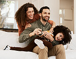 Happy parents, play and family child, mother and father laughing, care and enjoy quality time together, fun or home joke. Comedy, love and bonding mom, dad or playful people with kids on lounge sofa