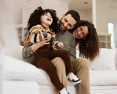 Buy stock photo Family, dad tickling kid and mom, laughter and happiness at home with bonding and love. Fun together, comedy and parents are playful with child, people being goofy on sofa with games and care