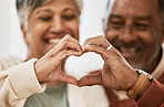 Heart, hands and happy senior couple in a living room with thank you, sign or gesture in their home together. Love, shape and old people show emoji frame in support of marriage, trust or retirement