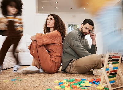 Buy stock photo Parents, floor and stress with kid running, toys and motion blur for speed, naughty or overwhelmed in house. Mother, father and child on carpet, living room or family home with chaos, mess or burnout