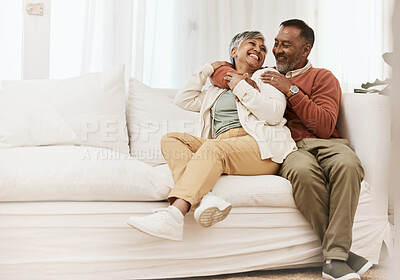 Buy stock photo Happy, laugh and senior couple hug on sofa with conversation, care and romance in their home. Smile, embrace and elderly man with woman in living room relax, talking and enjoying retirement in house